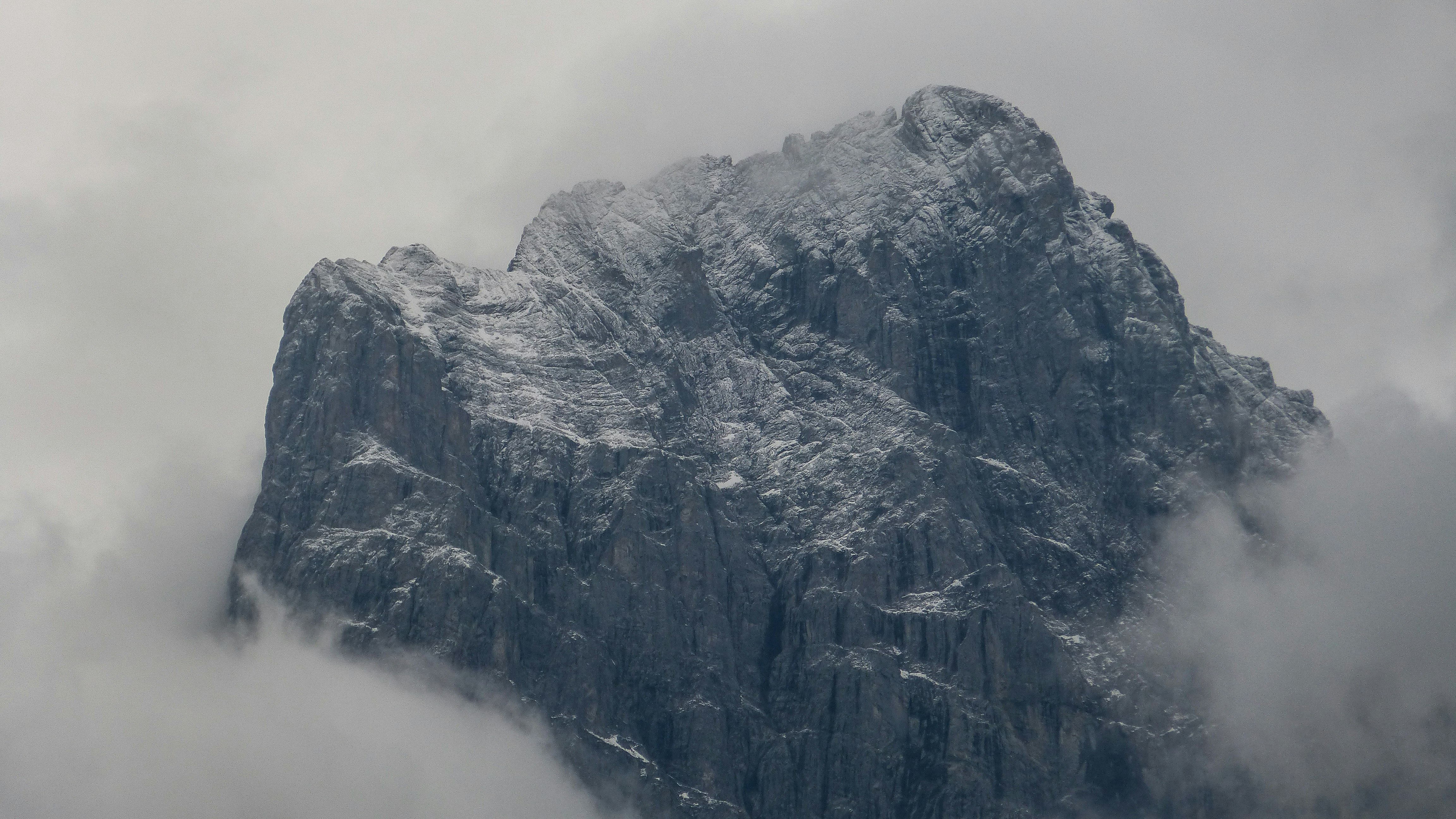 grey mountain under cloudy sky during daytime